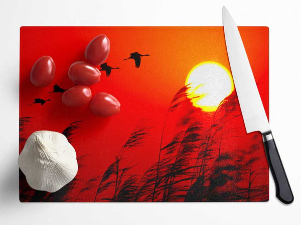 Geese In Flight Under The Red Sun Glass Chopping Board
