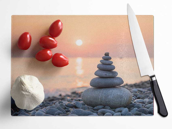 Zen Stones at sunset on the beach Glass Chopping Board