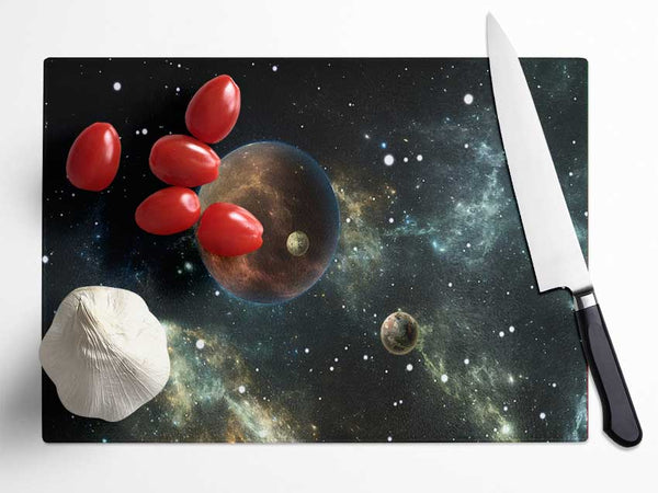 Planets in the dark skies Glass Chopping Board