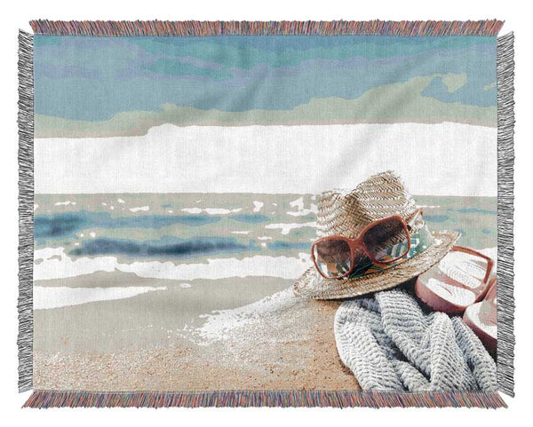 Sun hat and sunglasses on the beach Woven Blanket