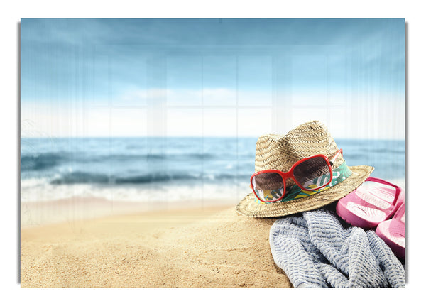 Sun hat and sunglasses on the beach