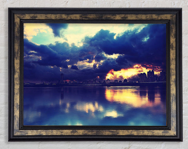 As The Sunset Beaks Through Over The City Framed Print