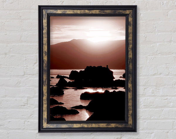 The Suns Mauve Ocean Rocks Framed Print