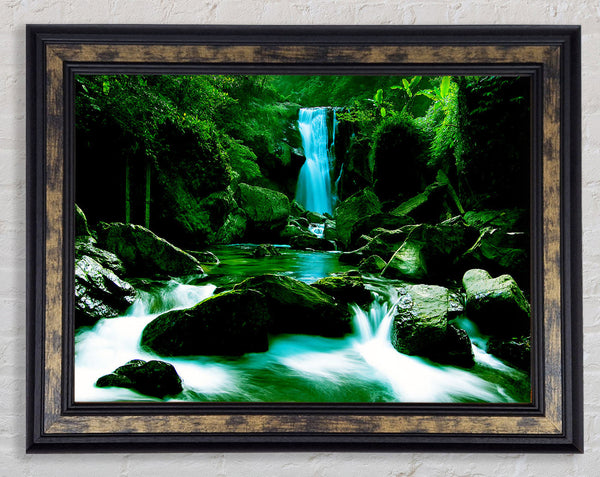 The Waterfall Flows Over The Rocks Framed Print