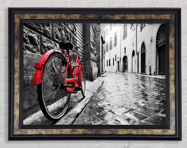 Red Bicycle In The Cobbled Streets Framed Print