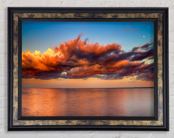 Red glowing clouds above the sea Framed Print
