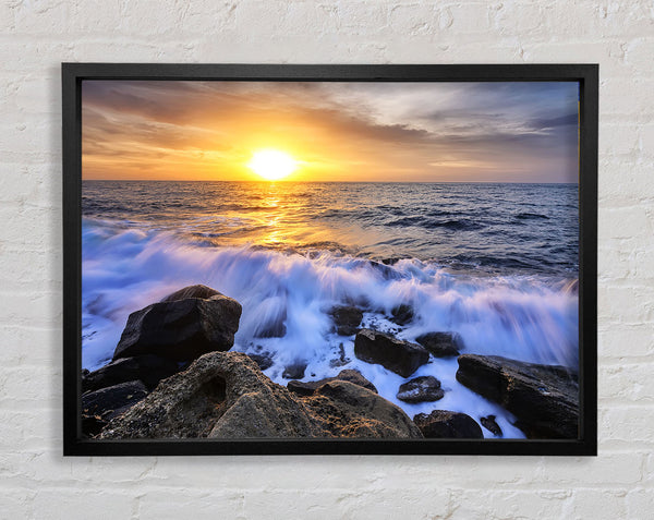 The waves crashing out at sea Framed Print