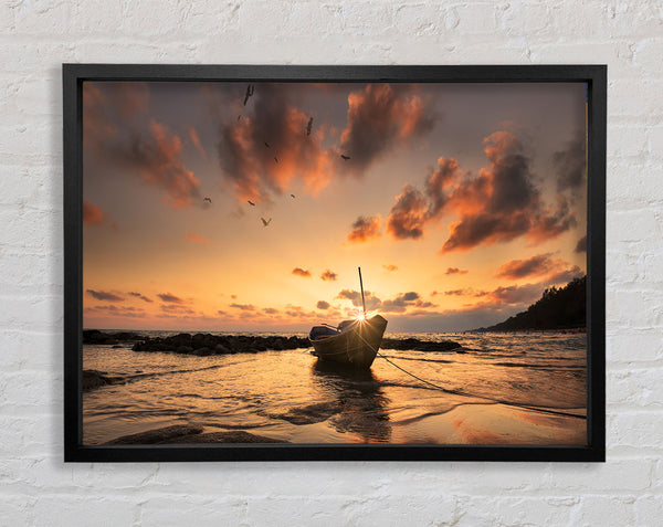 Sunset finishing boat on the beach Framed Print
