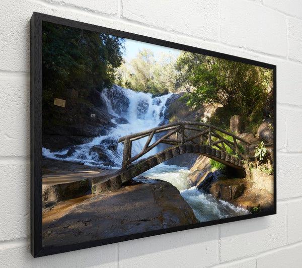 Rustic made bridge by a waterfall