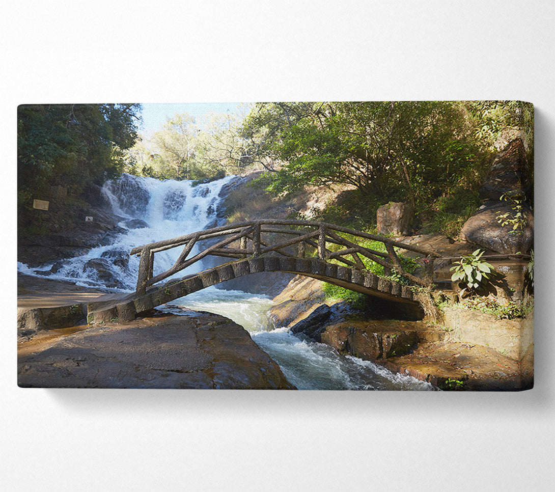  A Canvas Print of Rustic made bridge by a waterfall Canvas Print