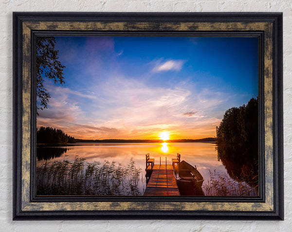 Rowing boat parked at the jeti Framed Print
