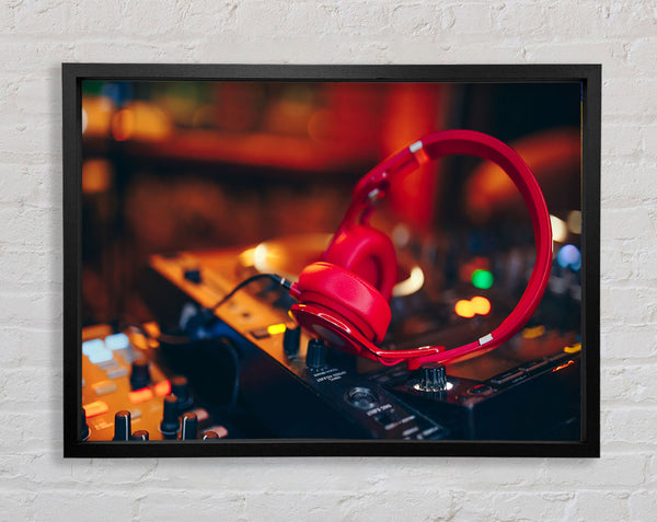 Red headphones on mixing desk Framed Print