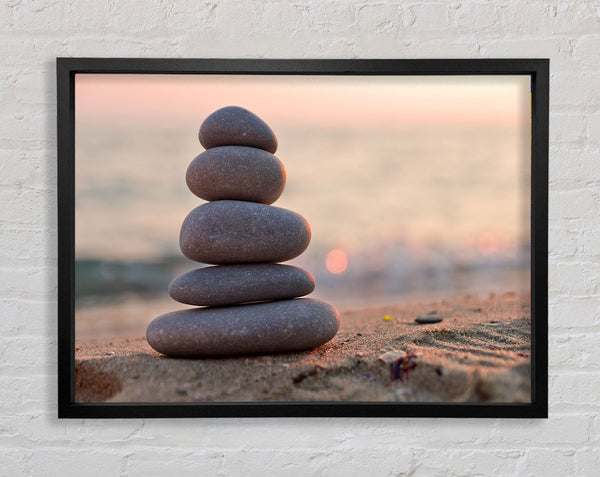 Zen stones stacked up on beach Framed Print