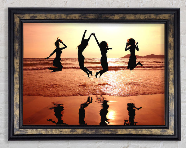 People jumping on the beach Framed Print
