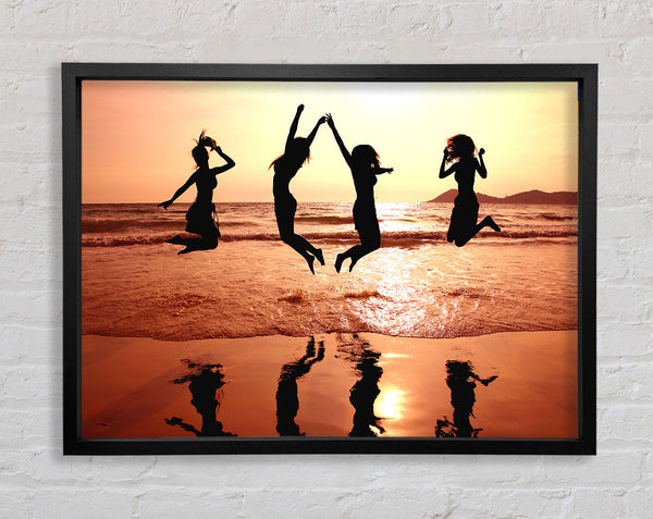 People jumping on the beach Framed Print