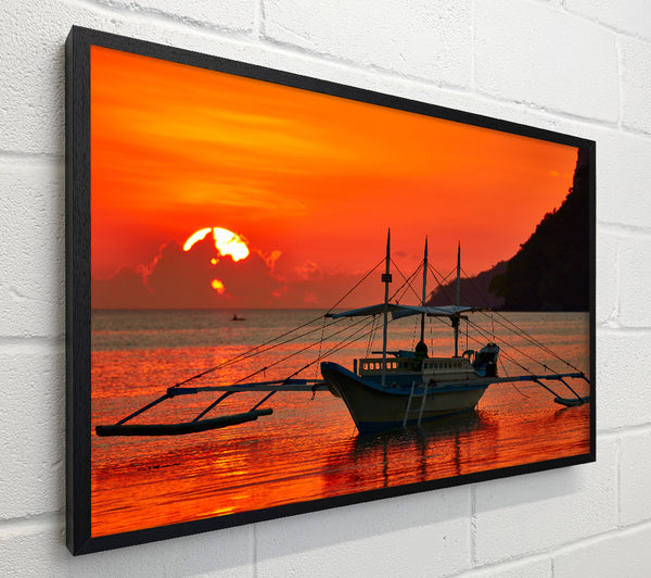 Boat sailing in the orange sunset