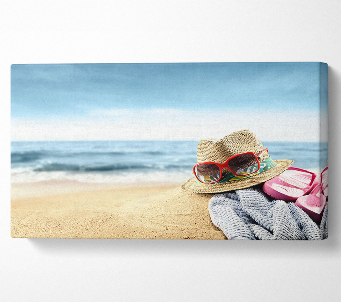 A Canvas Print of Sun hat and sunglasses on the beach Canvas Wall Art