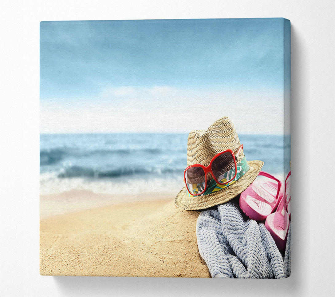  A Canvas Print of Sun hat and sunglasses on the beach Canvas Wall Art