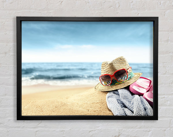 Sun hat and sunglasses on the beach Framed Print