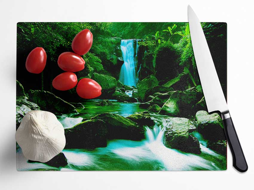 The Waterfall Flows Over The Rocks Glass Chopping Board