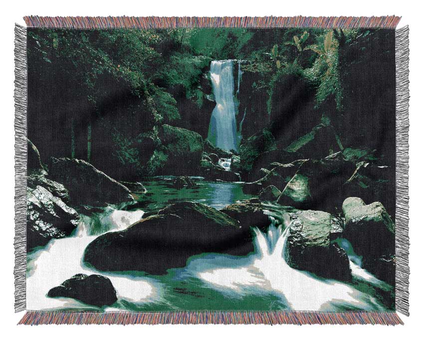 The Waterfall Flows Over The Rocks Woven Blanket