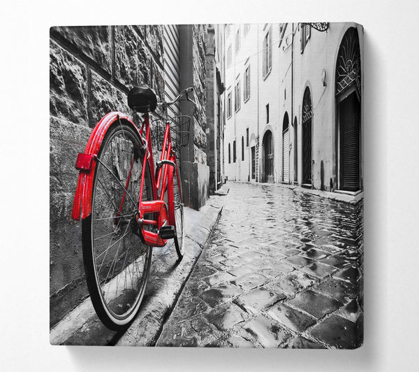 A Square Canvas Print Showing Red Bicycle In The Cobbled Streets Square Wall Art