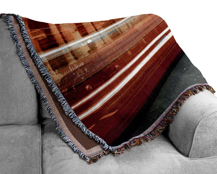 Red Bus Speeding Through The City Woven Blanket