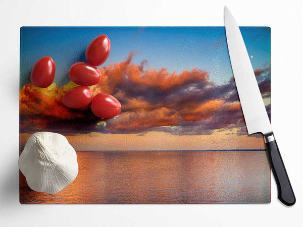Red glowing clouds above the sea Glass Chopping Board