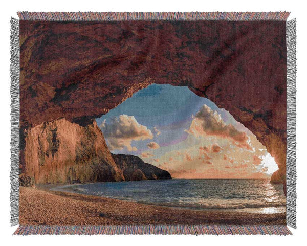 Cave on the coast Woven Blanket