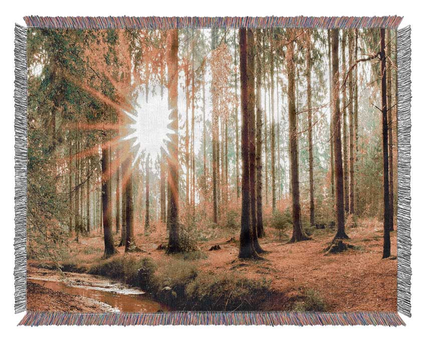 Sun appearing through the trees in britain Woven Blanket