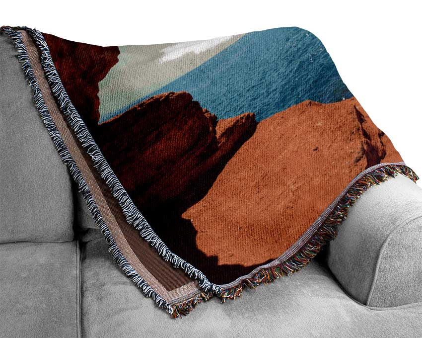 Sea from the view of a cave Woven Blanket