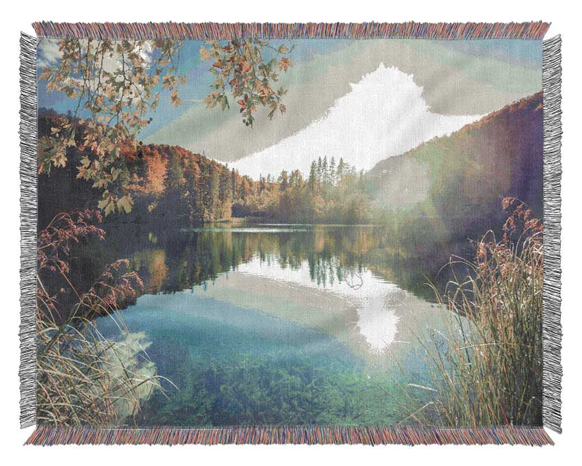 View of the lake through the branches Woven Blanket