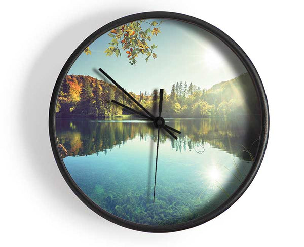 View of the lake through the branches Clock - Wallart-Direct UK