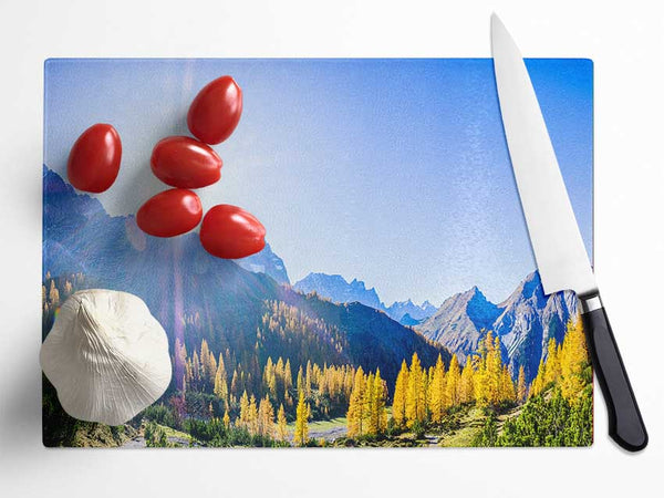 Mountain view of tall trees sunrise Glass Chopping Board