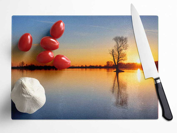 Sunset above the trees river Glass Chopping Board