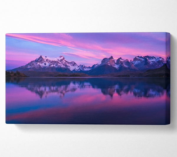 Purple and blue mountains above lake