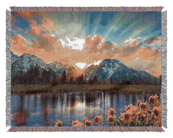 Flowers in front of the mountains Woven Blanket