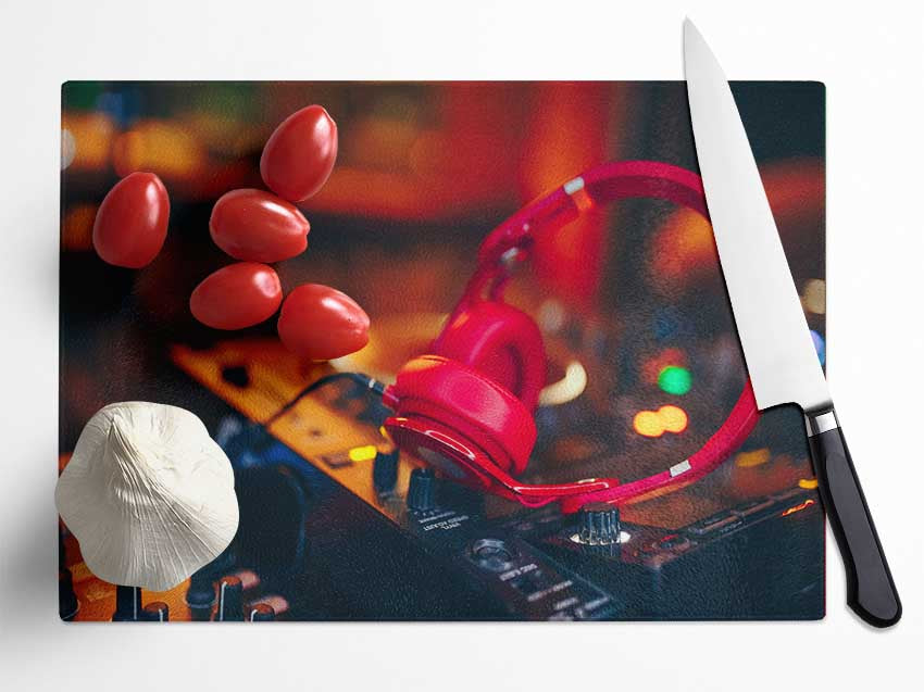 Red headphones on mixing desk Glass Chopping Board