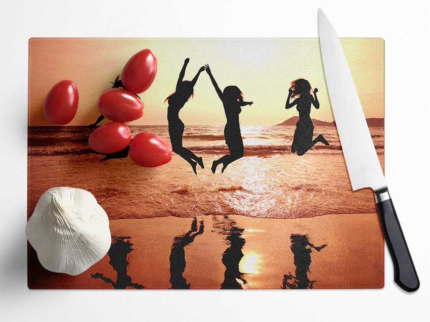 People jumping on the beach Glass Chopping Board