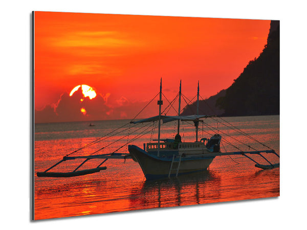 Boat sailing in the orange sunset Metal Print