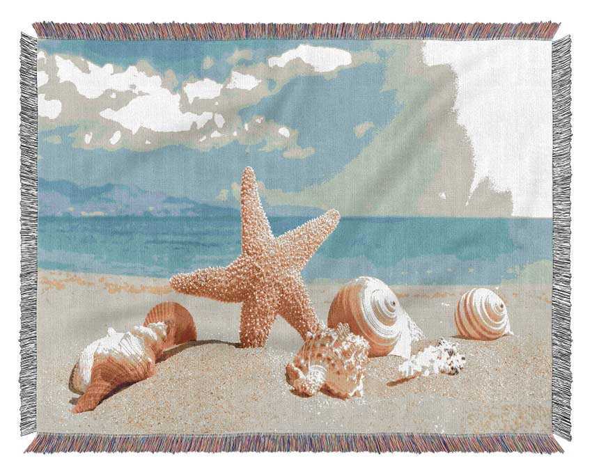 Starfish standing in the sand Woven Blanket
