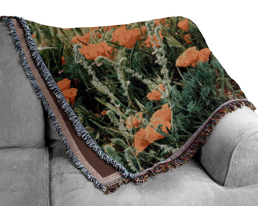 Orange flowers in the spring field Woven Blanket