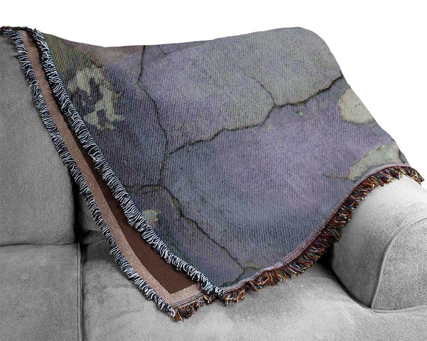 Simple street art on eroded wall Woven Blanket