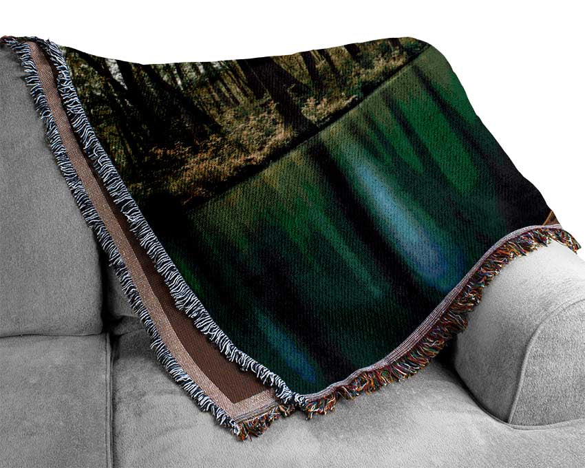Sitting on a row boat journey Woven Blanket