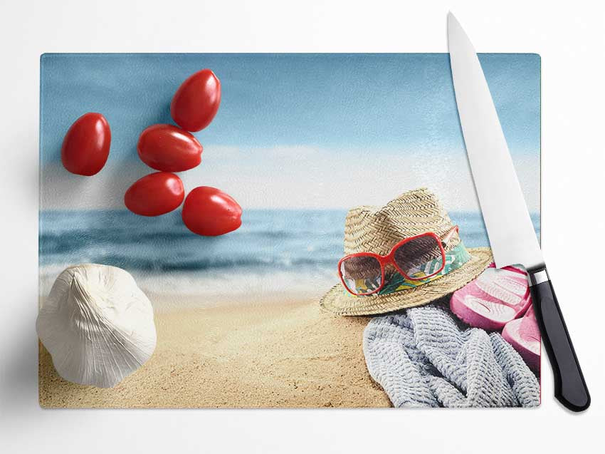 Sun hat and sunglasses on the beach Glass Chopping Board